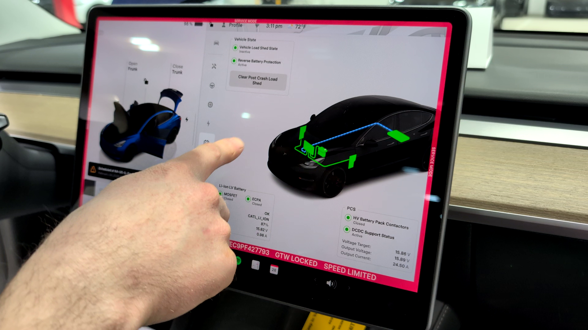 Technician pointing to Tesla Service Mode on a Model S screen